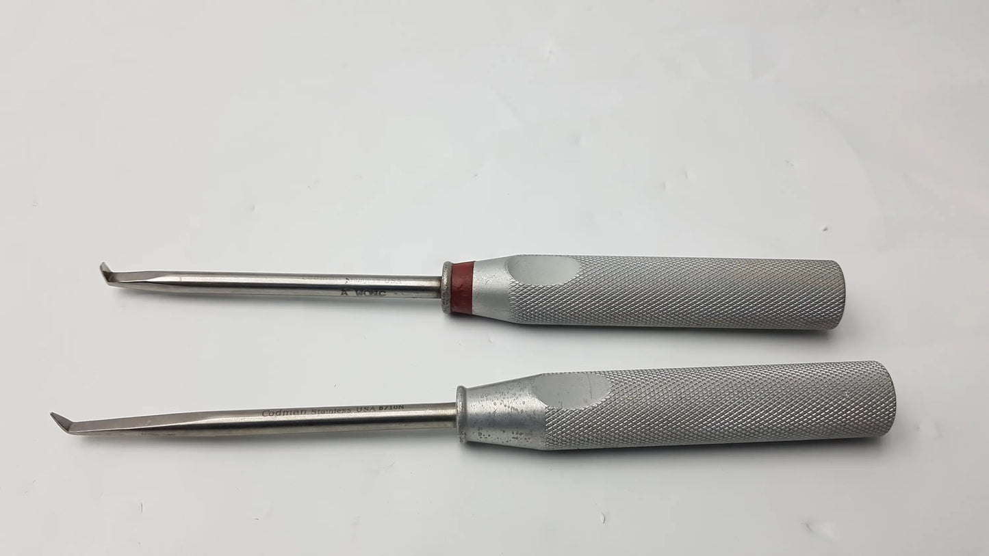 Lot of 2 codman 8710n osteophyte elevators with curved tips, textured gray handles, and red accents for orthopedic surgical use