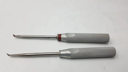 Lot of 2 codman 8710n osteophyte elevators with curved tips, textured gray handles, and red accents for orthopedic surgical use