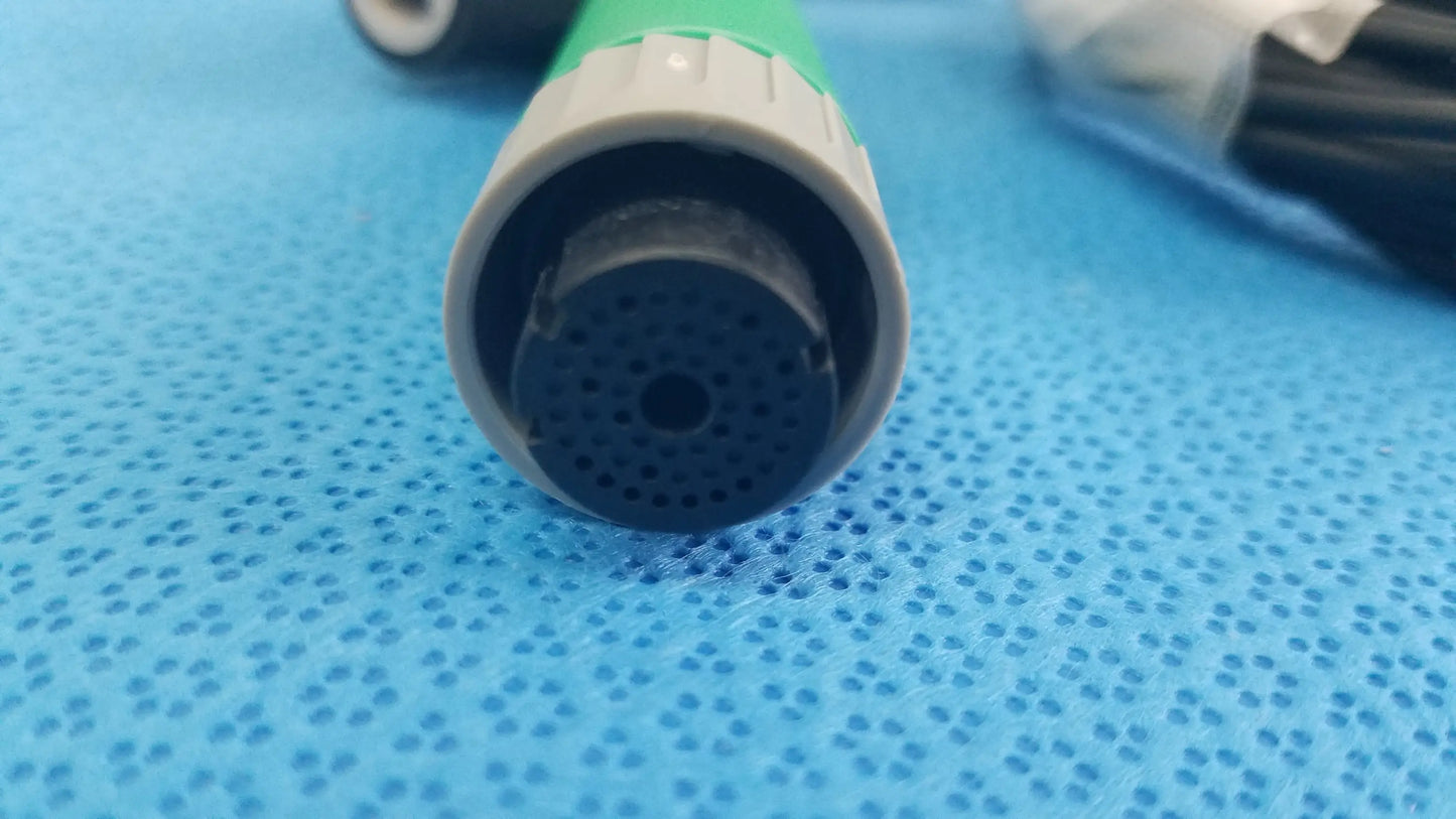 Green and gray plastic garden hose nozzle with perforated spray head shown with lot of 2 ensite x catheter connector cables for reuse medical equipment