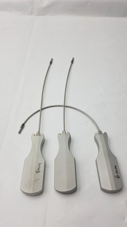 Three metallic surgical retractors with ergonomic handles and labeled sizes for slight curve long and curve long use