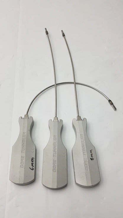 Three metallic gore tunneler surgical instruments with slight curve long and curve long wire handles and size markings