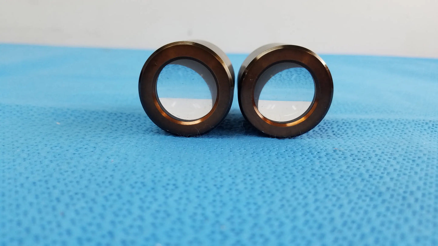 Two polished bronze swh10x microscope eyepieces with precision optical lenses for enhanced image clarity