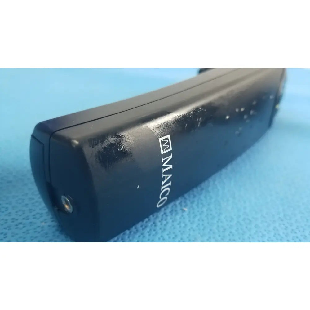 Black maico handheld auditory device with glossy finish and wear marks for hearing screening medical equipment use