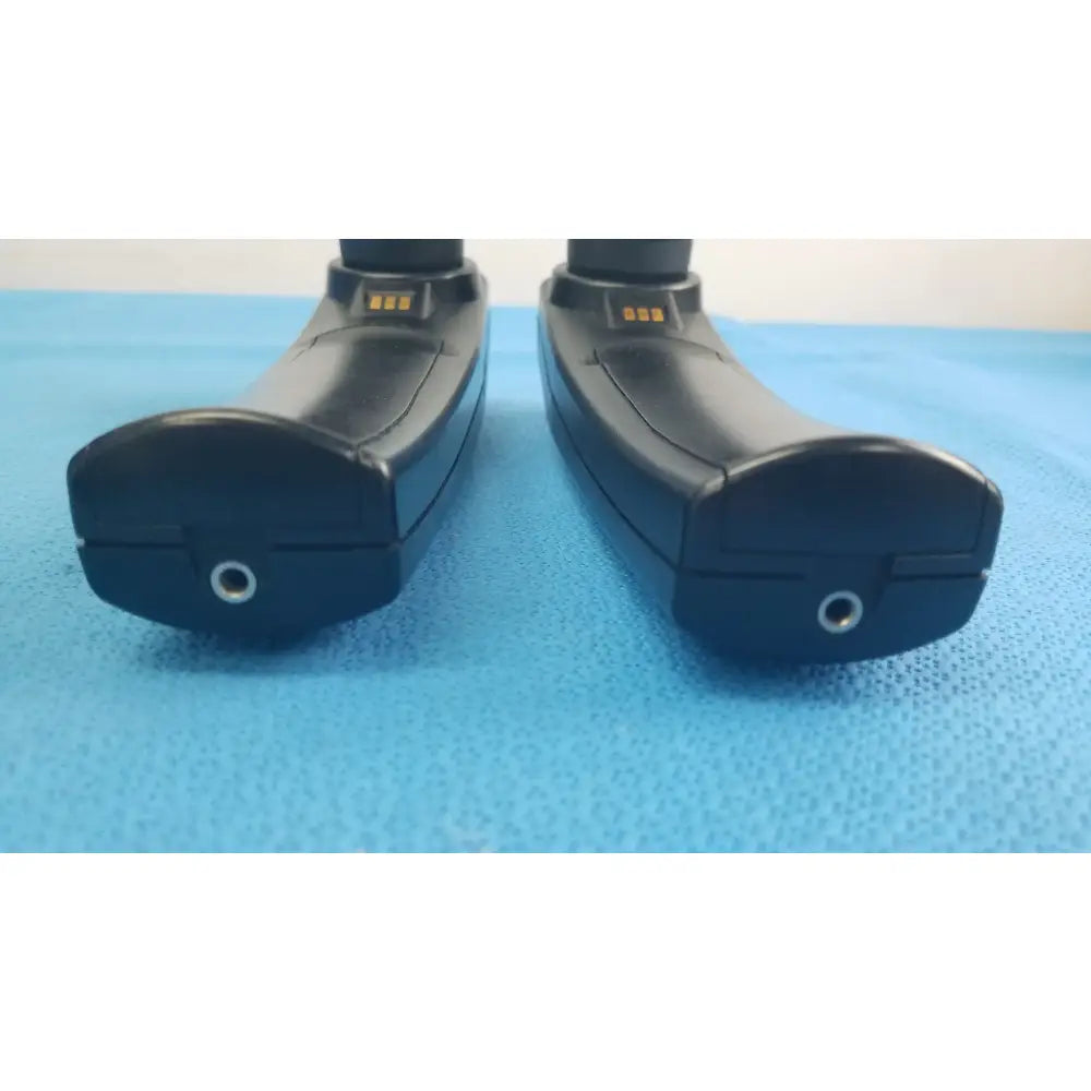 Lot of 2 maico ero scan pro handheld auditory devices with black ergonomic design metallic charging ports and gold contact strips for hearing screening medical equipment