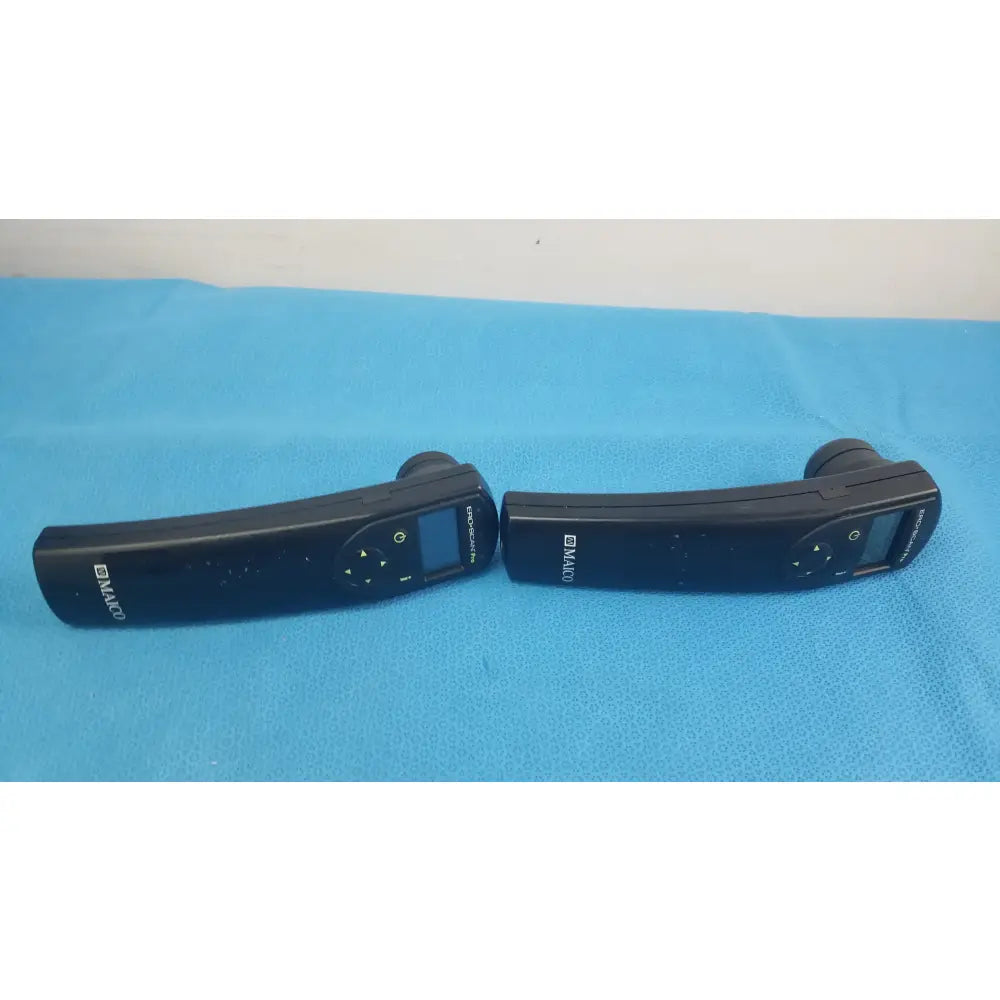 Lot of 2 black d-maco handheld auditory remote controls with digital displays and directional buttons for hearing screening