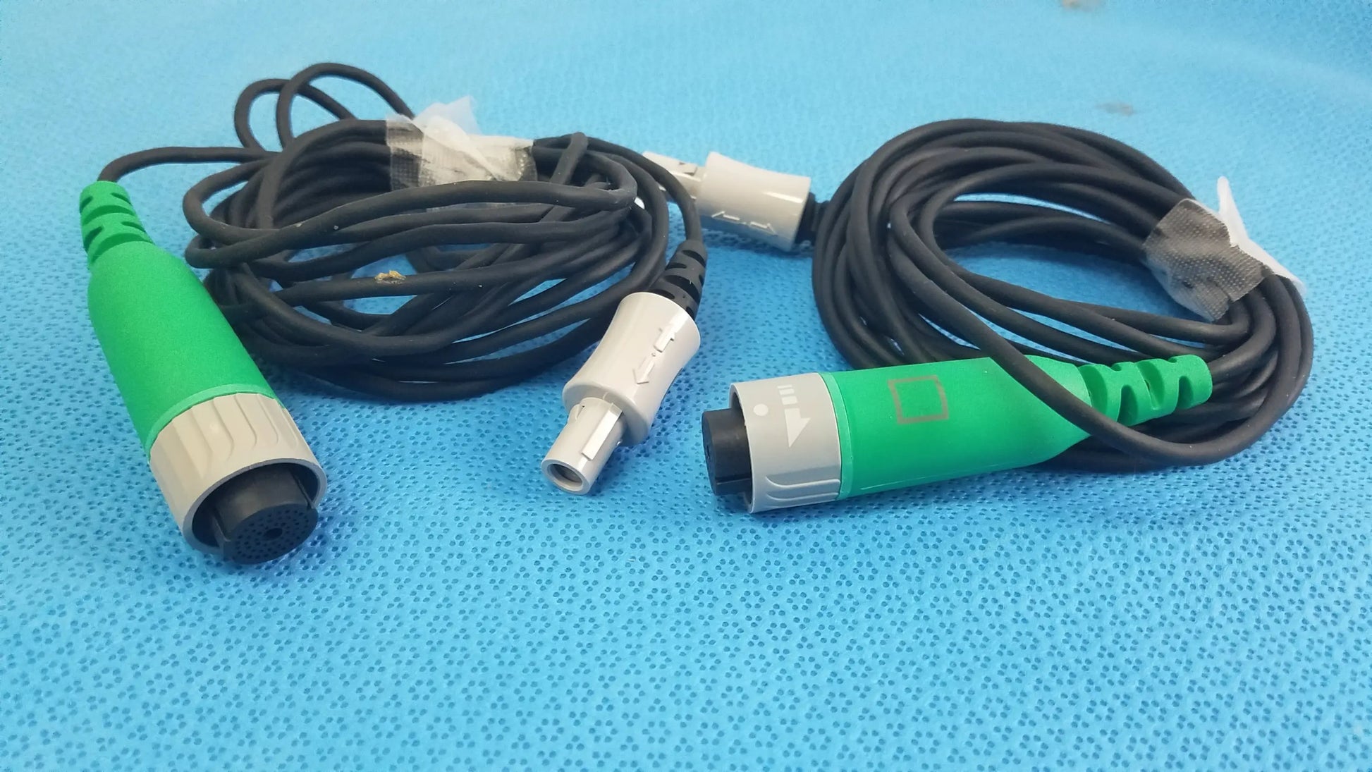 Lot of 2 stryker catheter connector cables with green and gray connectors and black coiled cords for medical equipment reuse