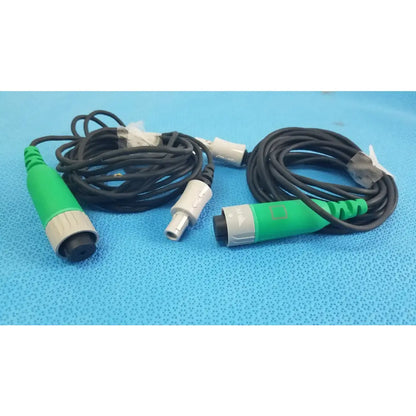 Lot of 2 stryker catheter connector cables with green and gray connectors and black coiled cords for medical equipment reuse