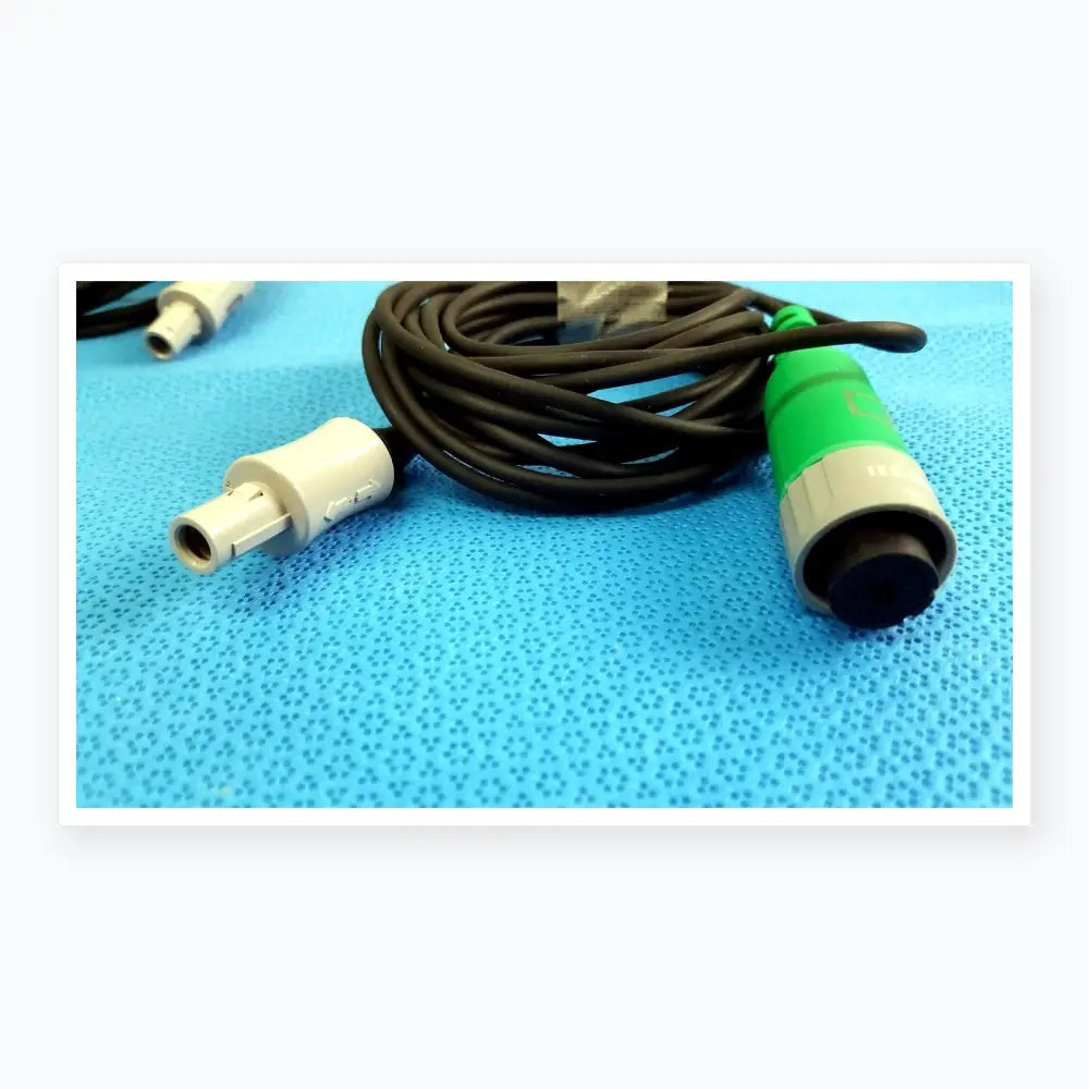 Lot of 2 Stryker catheter connector cables with black coiled cable, white connector, and green gray medical equipment plug