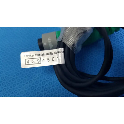 Lot of 2 black coiled stryker catheter connector cables with gray stryker sustainability solution label for medical equipment reuse