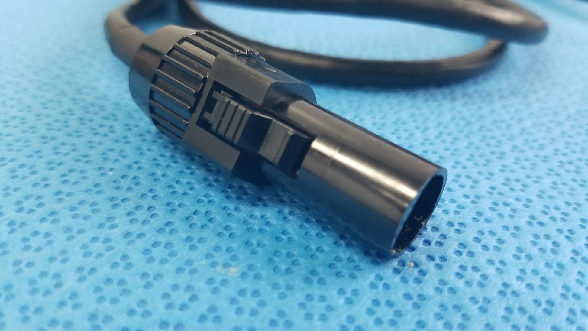 Black mc4 solar connector extension cable with ribbed textured grip and metallic finish for reuse medical equipment