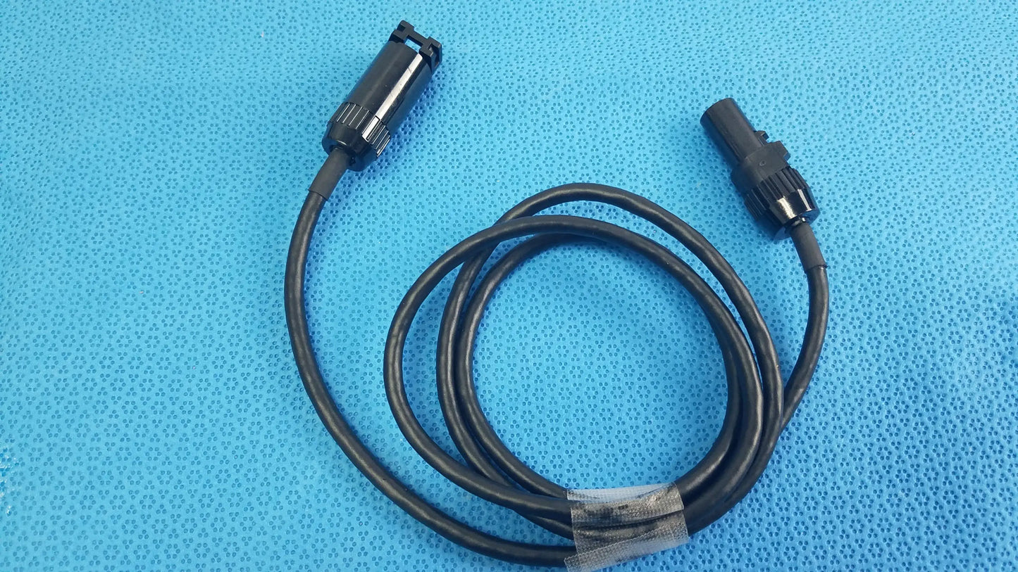 Black coiled mc4 solar connector extension cable with two black plastic connectors including threaded collar for reuse medical equipment