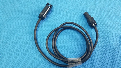 Black coiled mc4 solar connector extension cable with two black plastic connectors including threaded collar for reuse medical equipment