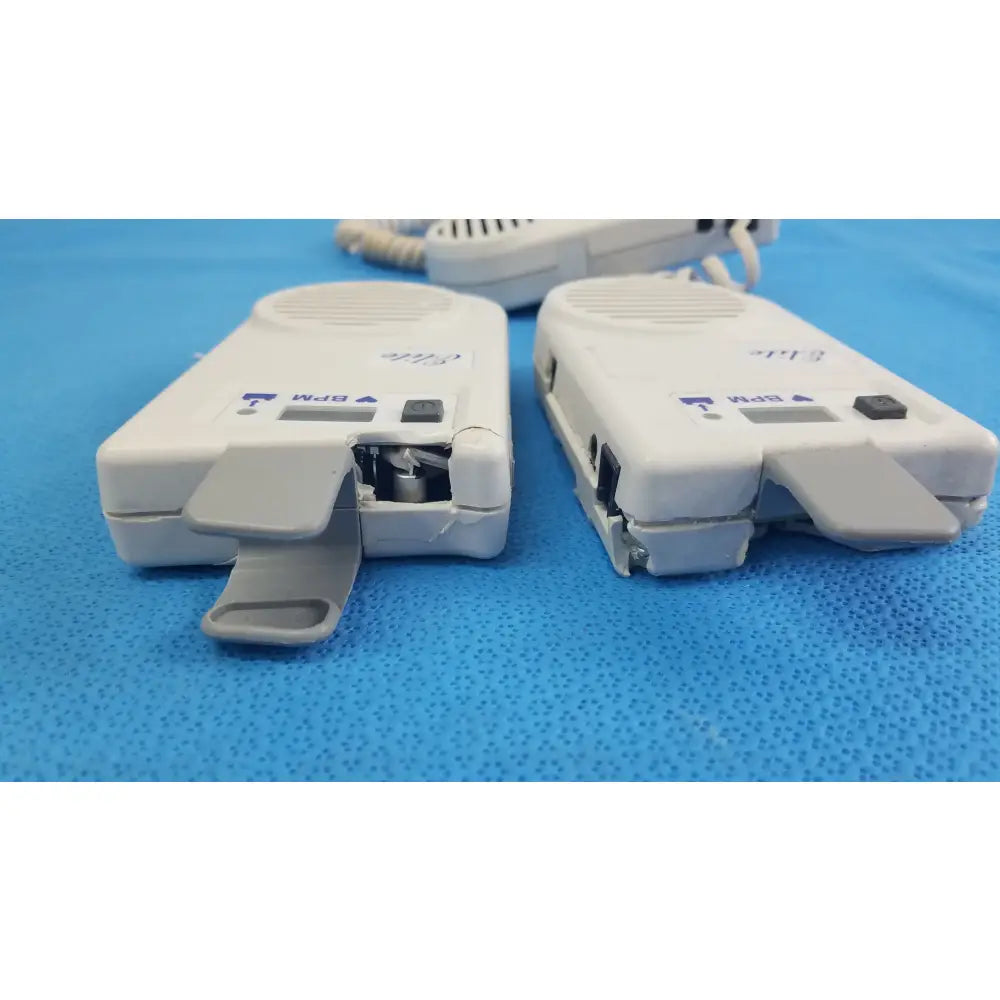 Lot of 3 natus neurology elite 200r handheld dopplers showing white plastic two-way radios with visible internal components