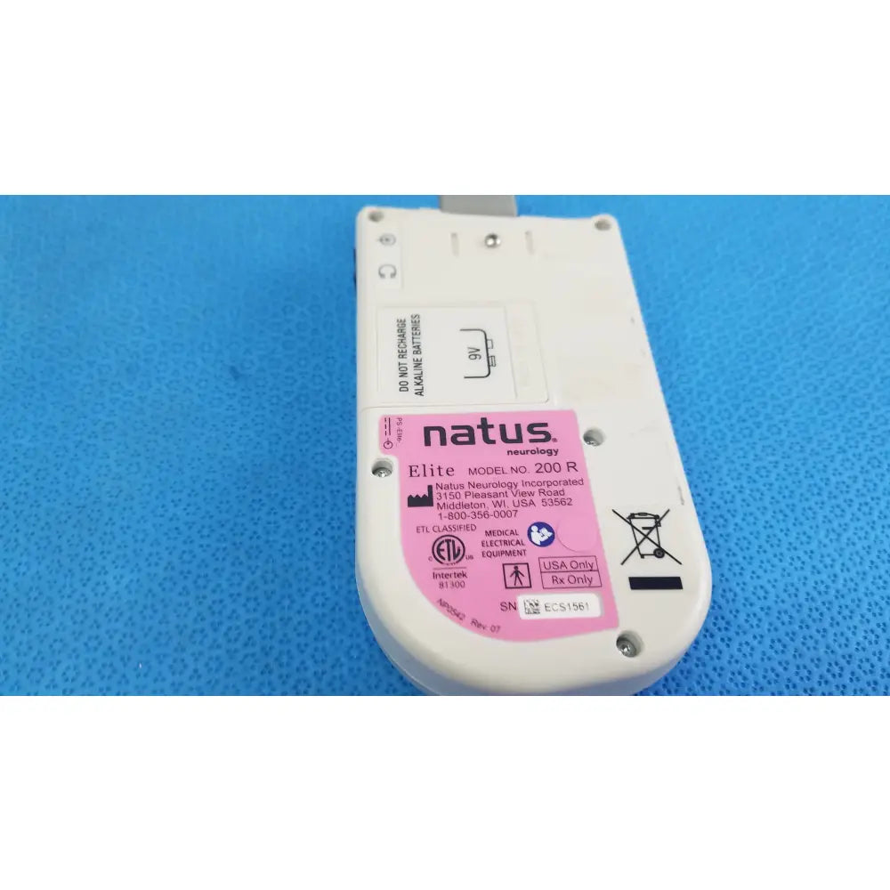 White plastic handheld doppler medical equipment labeled natus neurology elite model 200r with pink sticker and regulatory markings