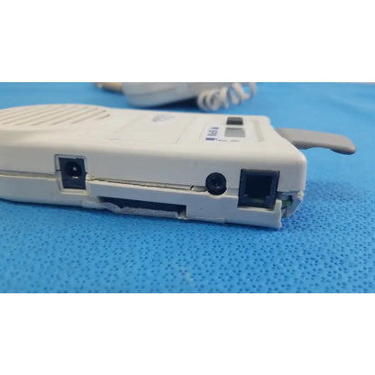 White plastic handheld doppler with pink label and gray mesh, natus neurology elite 200r medical equipment for reuse