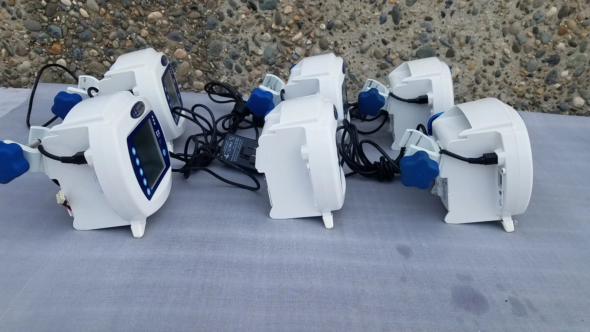 Lot of 6 white Covidien enteral feeding pumps with blue knobs and digital displays compatible with kangaroo epump
