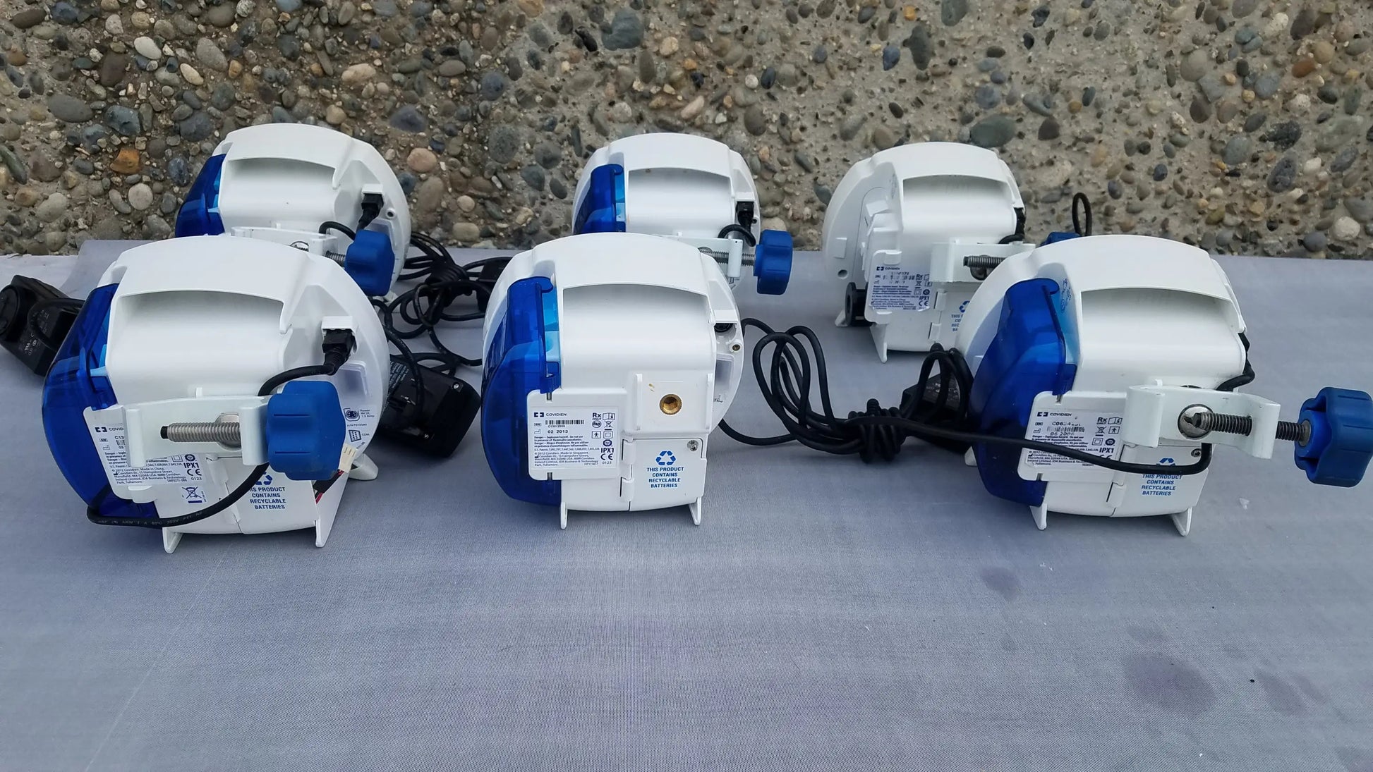 Lot of 6 covidien enteral feeding pumps with white and blue plastic bodies, black cords, and compatible kangaroo epump design