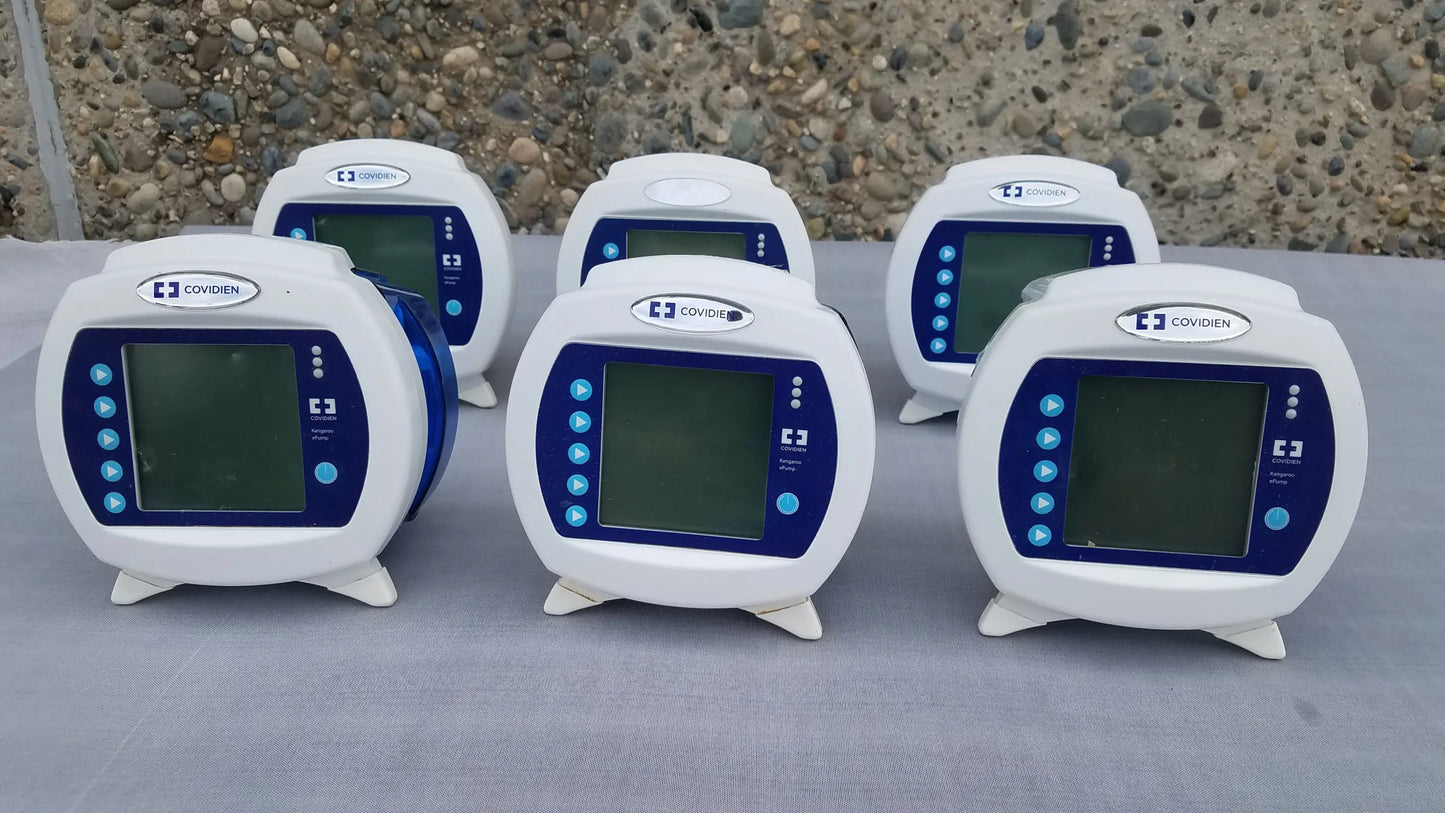 Lot of 6 covidien kangaroo epump enteral feeding pumps with white and blue casing and rounded rectangular screens