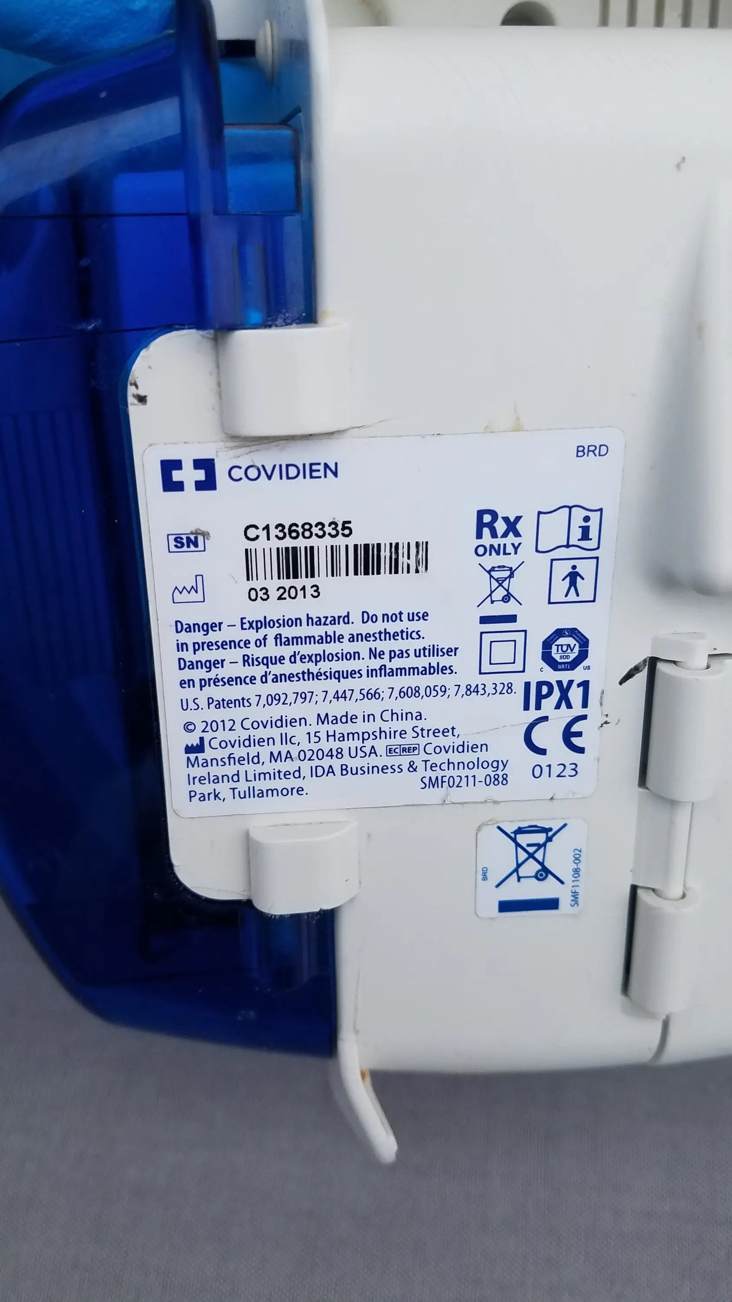 White plastic kangaroo epump enteral feeding pump with blue translucent casing and explosion hazard label by covidien