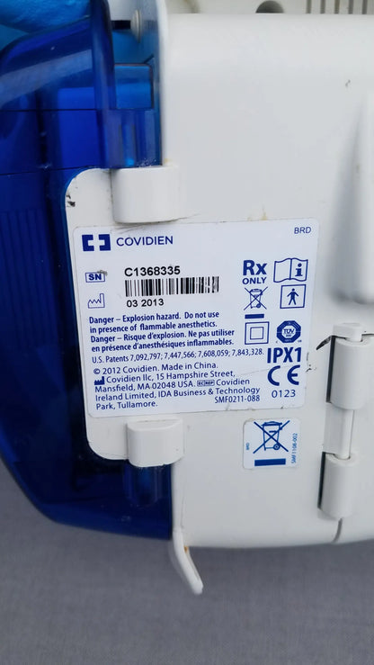 White plastic kangaroo epump enteral feeding pump with blue translucent casing and explosion hazard label by covidien