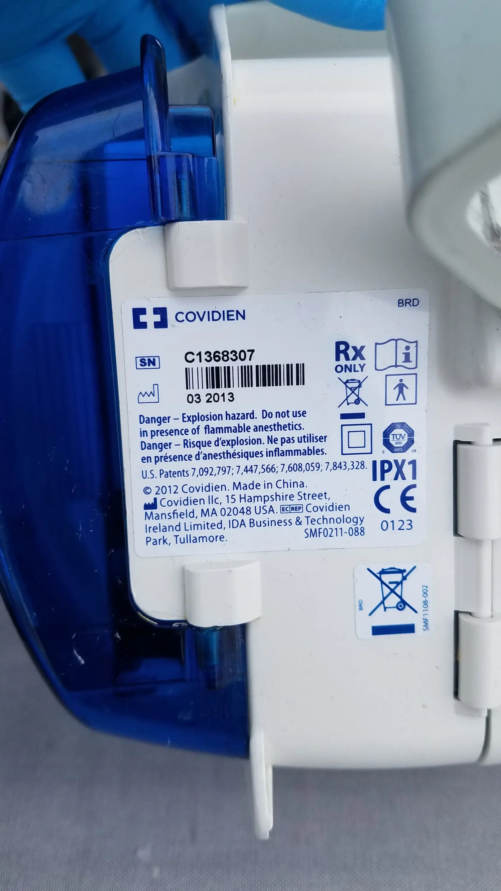 Blue and white plastic kangaroo epump enteral feeding device with covidien label and regulatory information visible