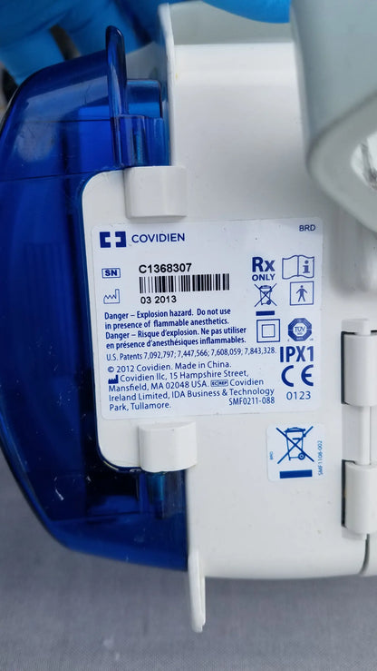 Blue and white plastic kangaroo epump enteral feeding device with covidien label and regulatory information visible