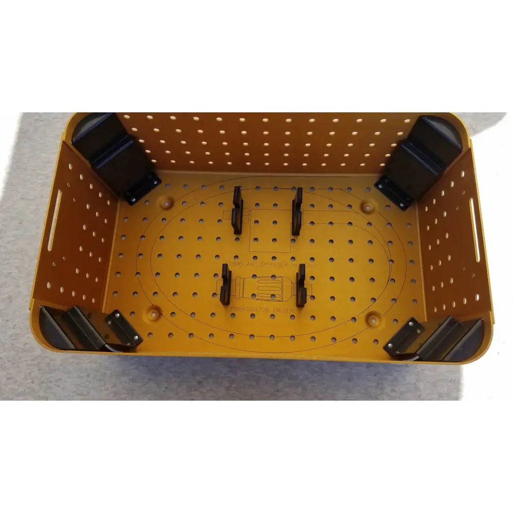 Yellow perforated plastic diffuser housing perforator basket with black corner supports and internal mounting brackets