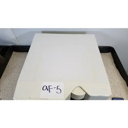 Off-white rectangular Luminex 200 xMap multiplex ruo system device with triangular cutout and handwritten af-5 label