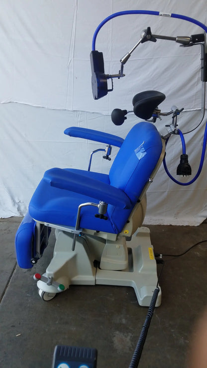 Blue magstim tms therapy chair with articulating arm, stimulation coil, adjustable armrests, and headlight attachment