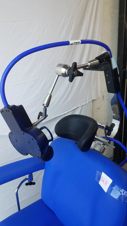 Blue magstim therapy chair with black cushioned pads, articulating arm, stimulation coil, and curved tube frame