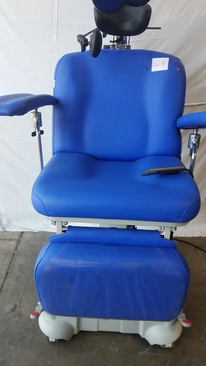 Blue upholstered Magstim TMS therapy chair with adjustable headrest footrest articulating arm and stimulation coil