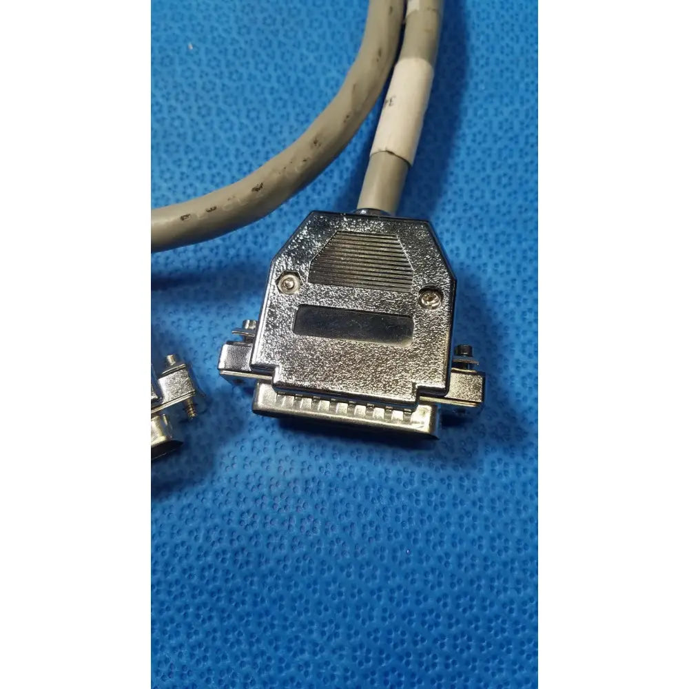 Silver-colored metal male pin connector data cable with gray cable and rectangular housing featuring multiple pins