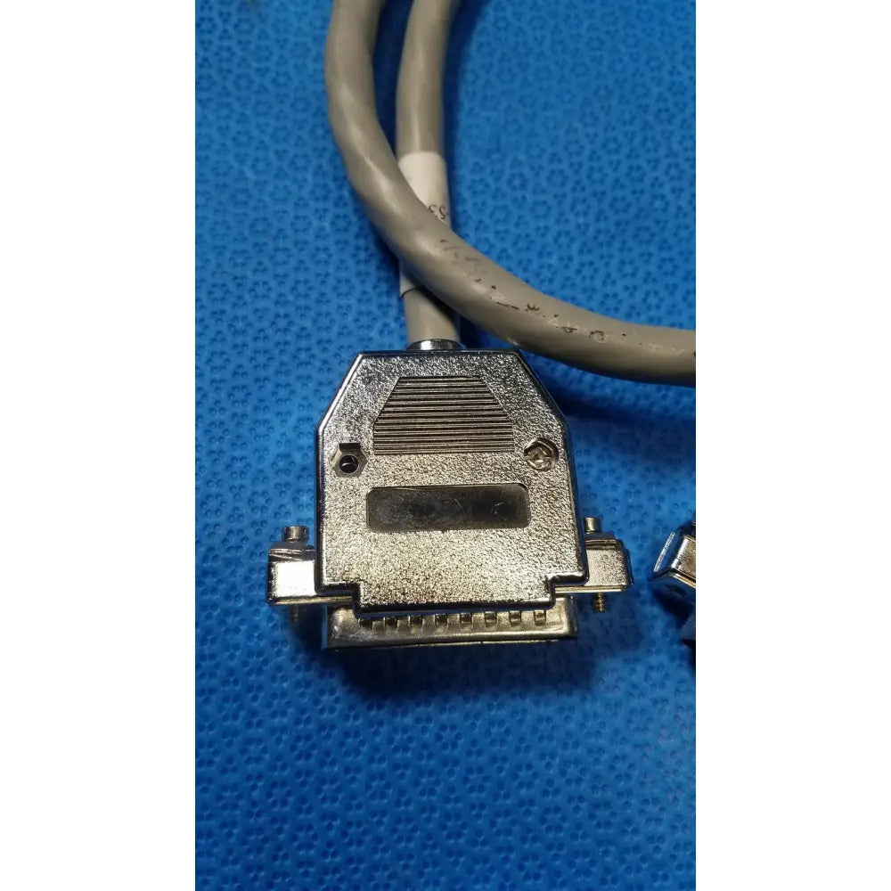 Gray cable with metallic rectangular male pin connector featuring textured surface and screw holes for pin connector data use