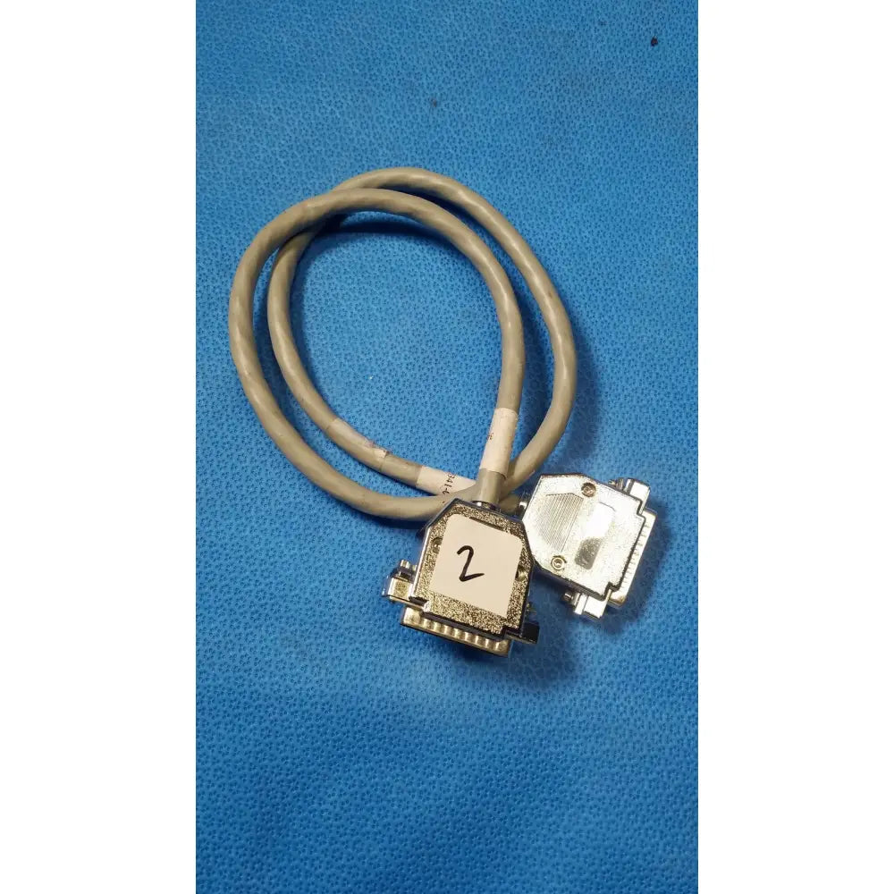 Gray coiled male pin connector data cable with two metallic d-sub connectors and one labeled 2 on white sticker