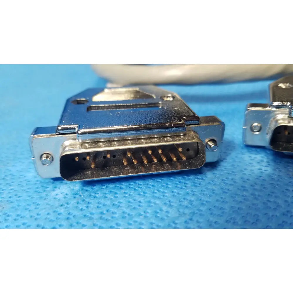 Silver-colored metal male pin connector with gold-plated pins and rectangular housing for pin connector data cables