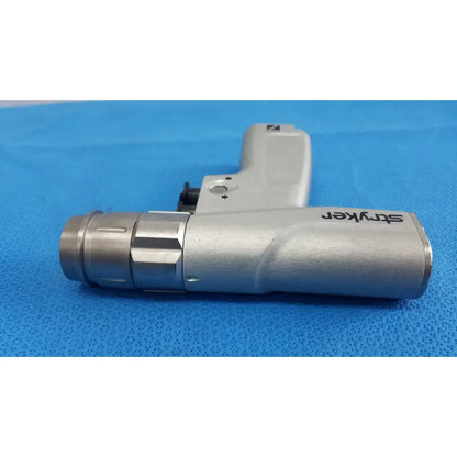 Silver stryker surgical instrument with textured grip and metallic barrel paired with masimo lnc-04 patient cable 4ft