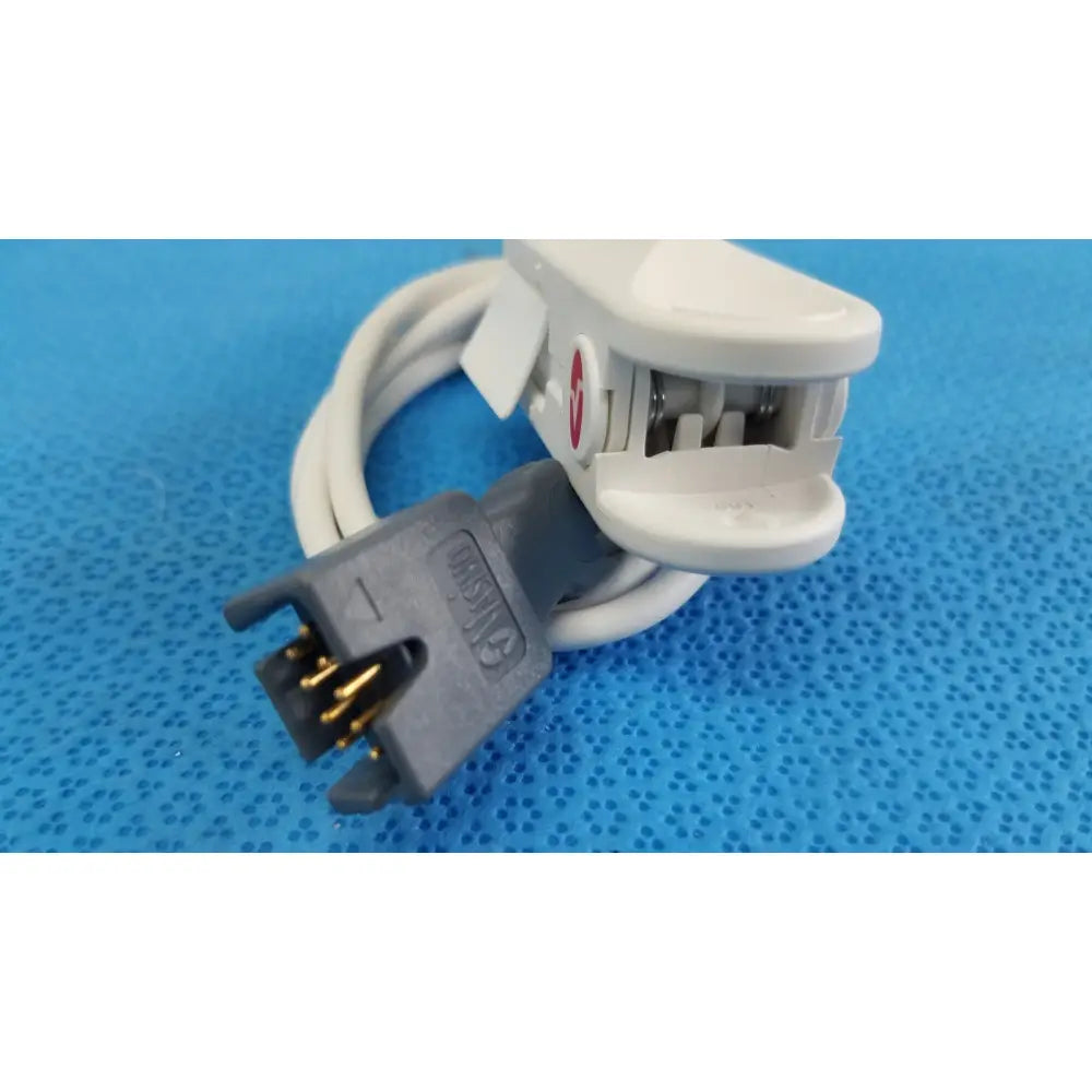 White plastic masimo lncs dci adult spo2 finger clip sensor with gray connector gold pins and red circular logo side view