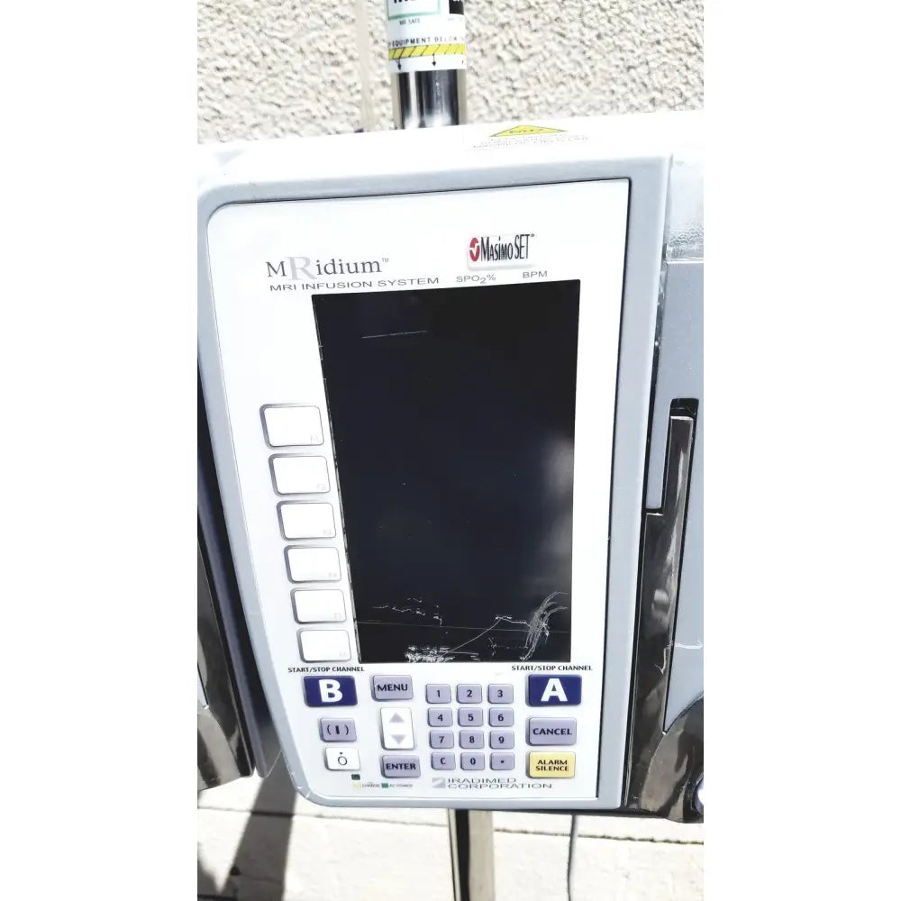 White masimo mridium 3600+ mri infusion pump monitoring system control panel with cracked screen and labeled buttons