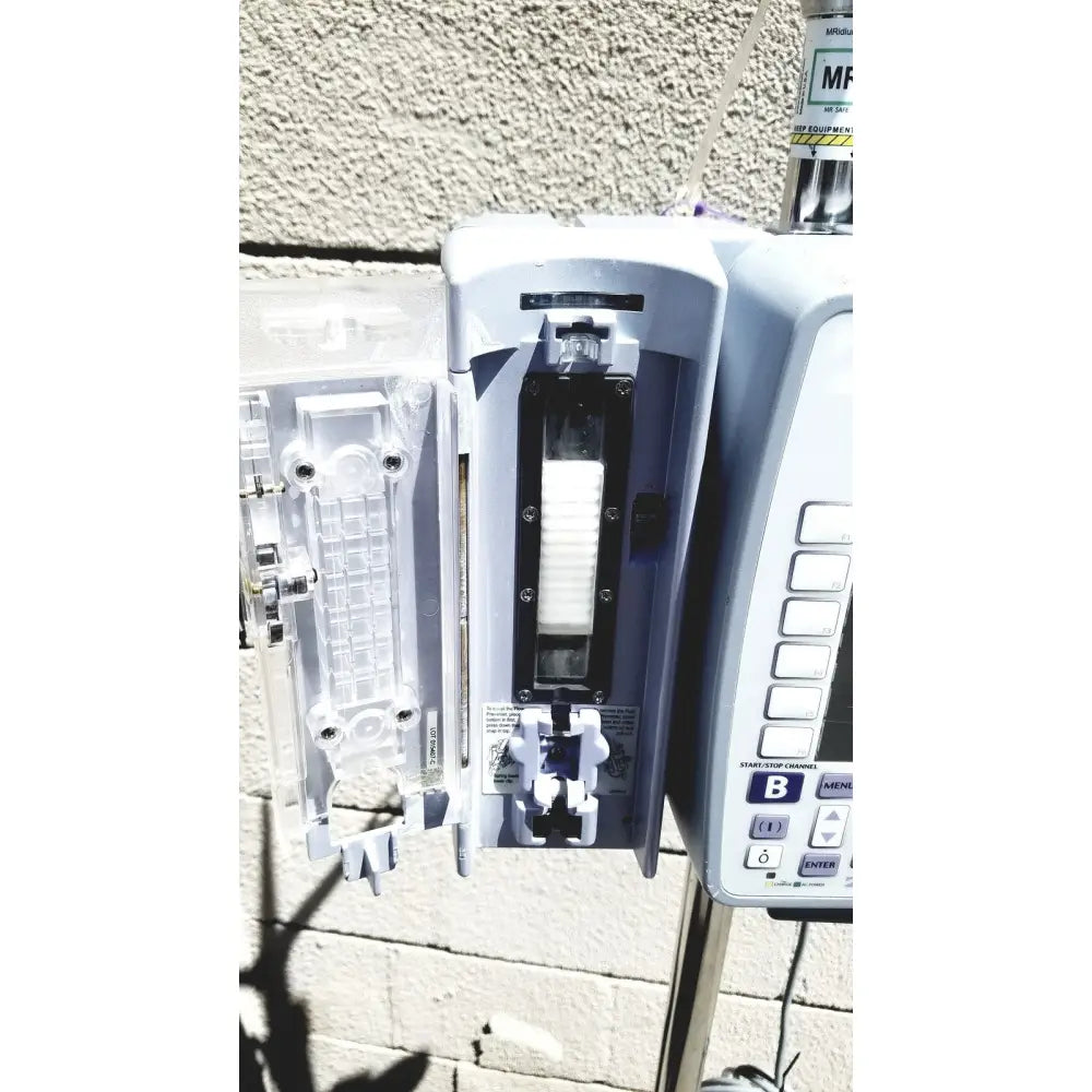 White plastic masimo mridium 3600 plus mri infusion pump with clear medication compartment and pump monitoring systems