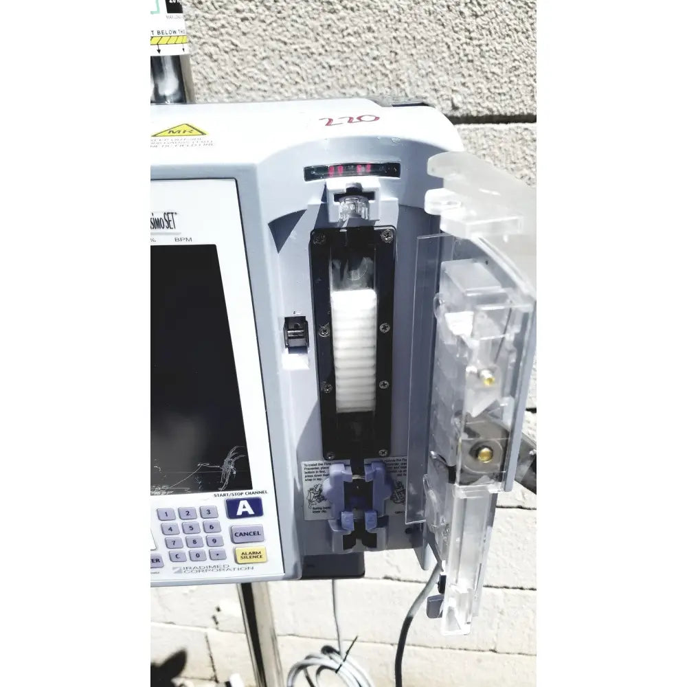 White masimo mridium 3600 plus mri infusion pump with digital display and clear compartments for pump monitoring systems