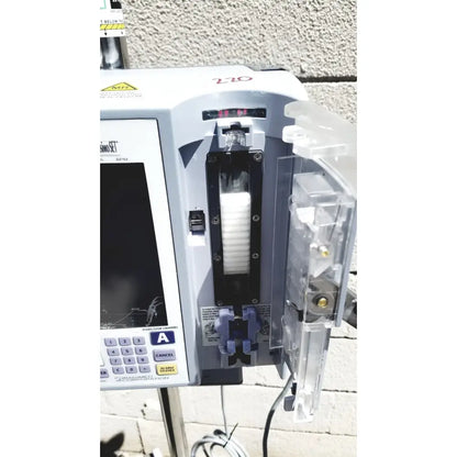 White masimo mridium 3600 plus mri infusion pump with digital display and clear compartments for pump monitoring systems