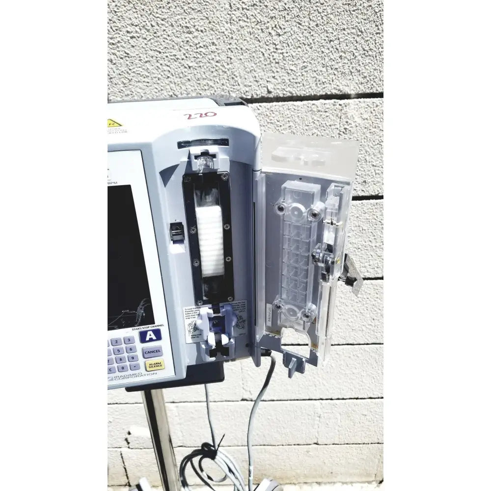 Masimo Mridium 3600+ gray mri infusion pump with digital display and transparent fluid chamber for pump monitoring systems