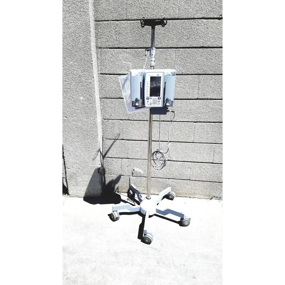 White masimo mridium 3600 plus mri infusion pump on a wheeled stand for infusion pump monitoring and pump monitoring systems