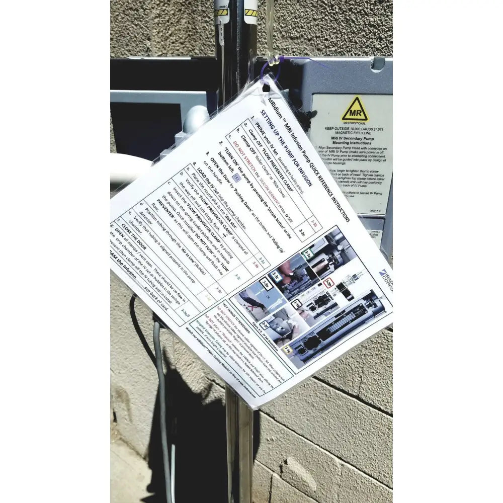 White paper instruction sheet with black text and diagrams on gray masimo mridium 3600 plus mri infusion pump monitoring system enclosure