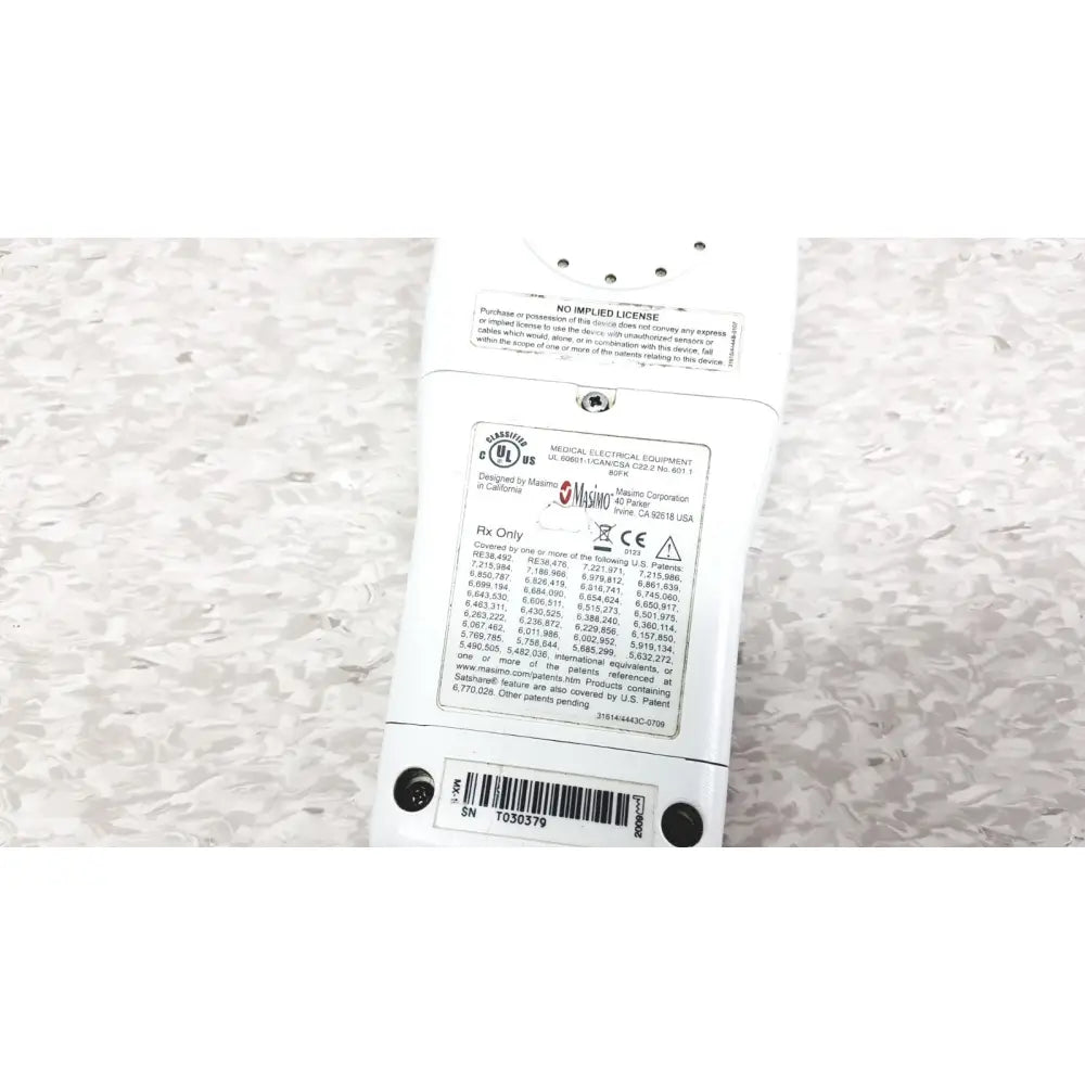 White plastic power strip with multiple outlets and certification label at the back of masimo radical-7 signal pulse oximetry touch color patient monitor