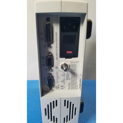 White industrial power supply unit with multiple serial ports and ventilation slots for masimo radical signal extraction pulse oximeter back side