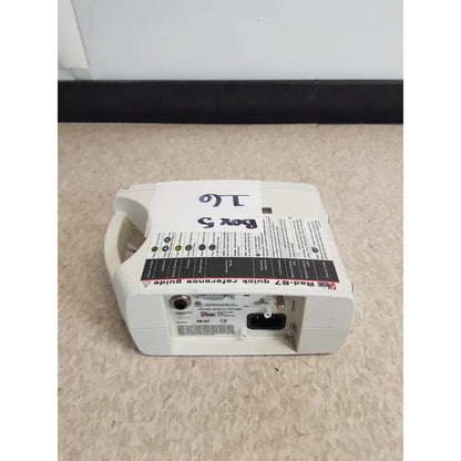 White plastic masimo set rainbow rad 87 pulse oximeter back side with black and red labeling power port and connectors