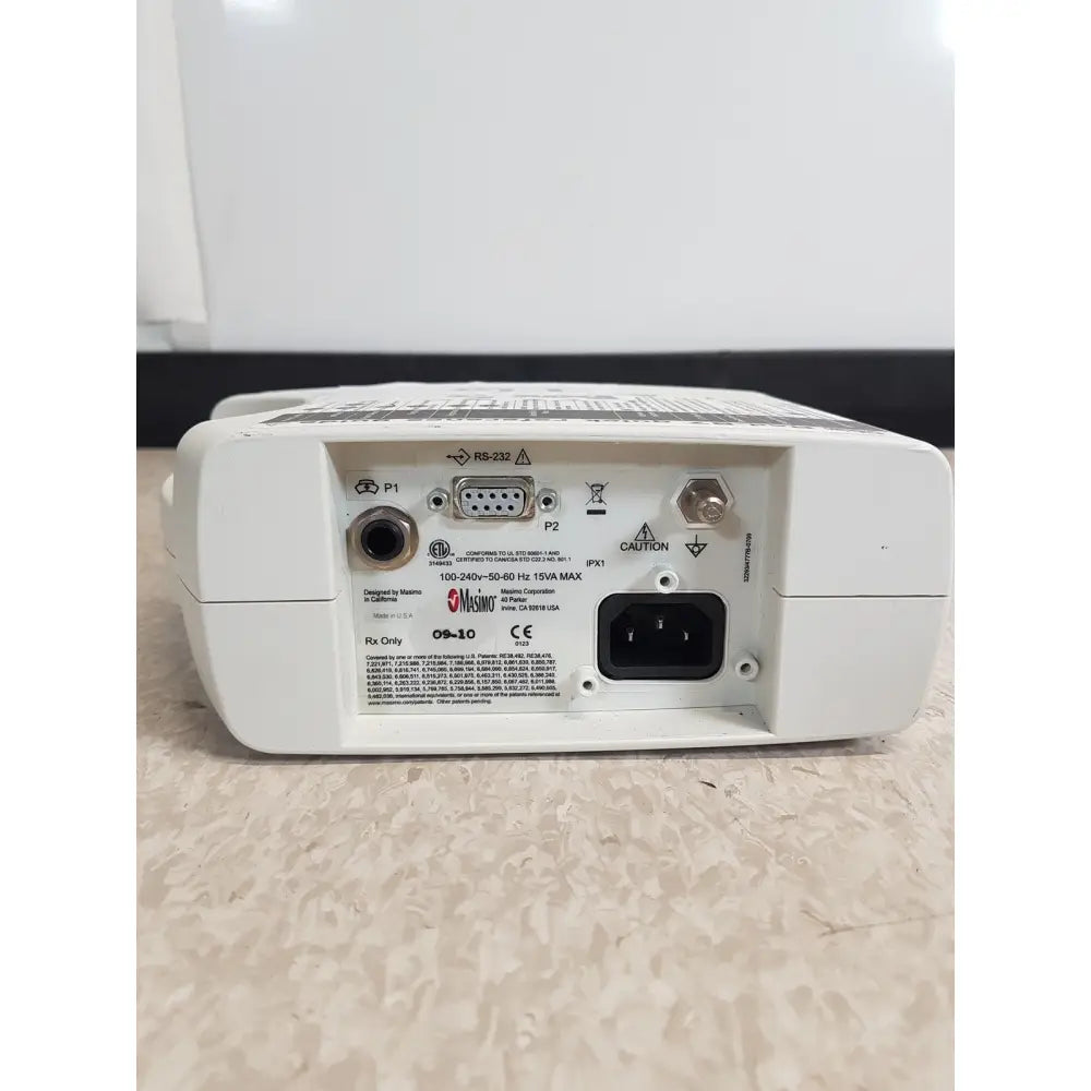 White plastic back panel of masimo set rainbow rad 87 medical monitor with multiple ports including rs 232 and power input socket
