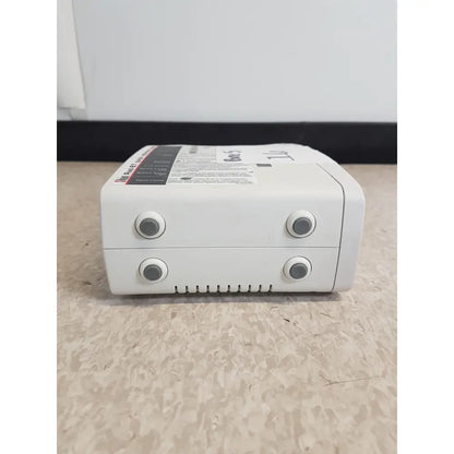 White plastic masimo set rainbow rad 87 pulse oximeter with four gray buttons and vented grille on front panel