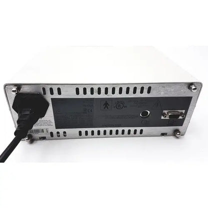 Silver metallic masimo surgical extraction pulse oximeter rear panel with black power cord and certification labels